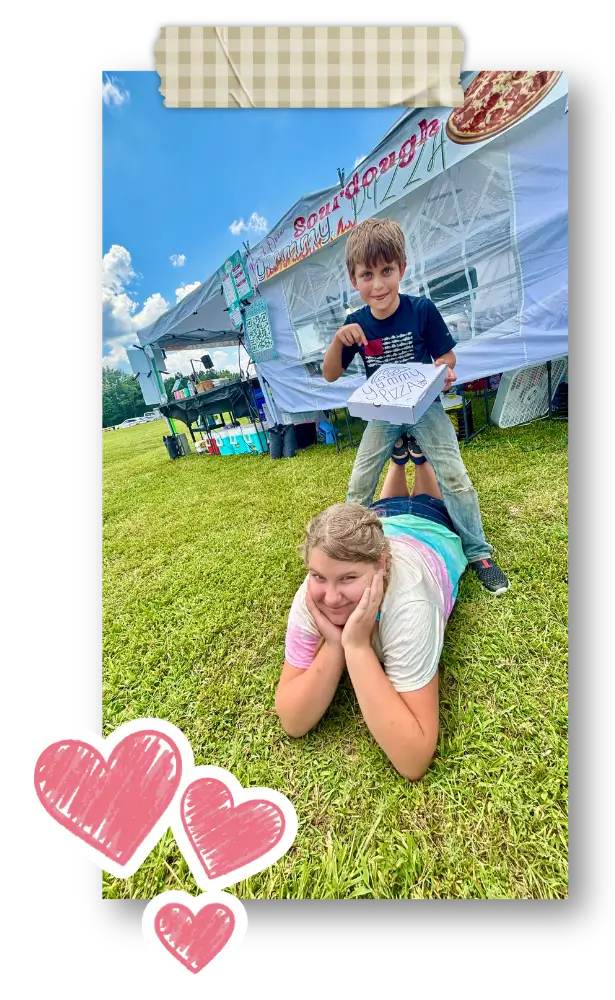 two kids with pizza box at fest